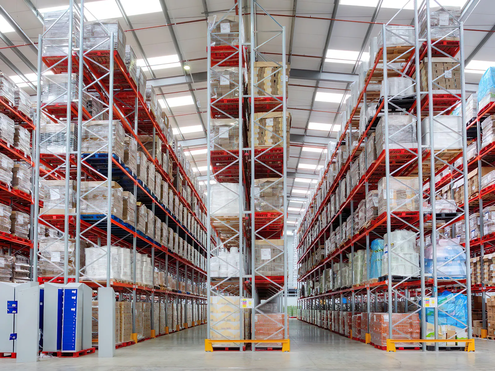 Pallet racking stacked stories high down the aisles of a distribution warehouse